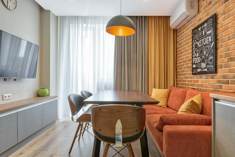 a living room that has a brick wall and wooden table