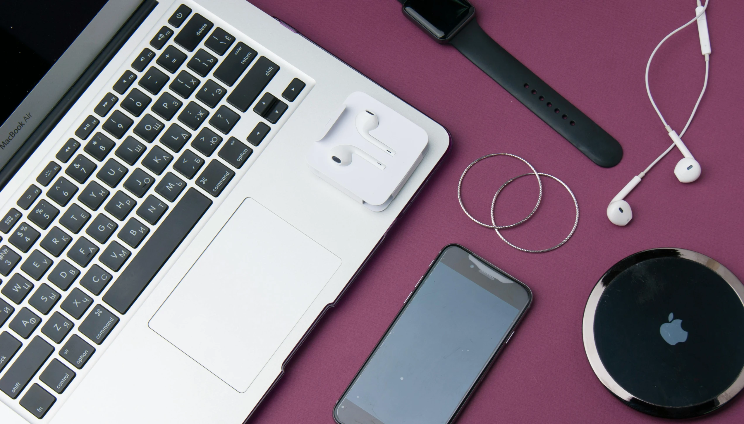 a laptop computer sitting on top of a pink table, airpods, detailed product image, square, high resolution image