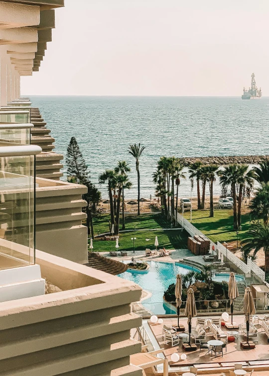 a el balcony with a pool and lots of palm trees