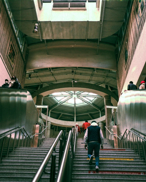 people standing on the top of a metal staircase