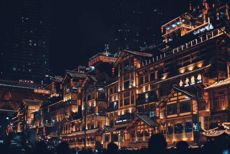 a large building lit up in the night with christmas lights