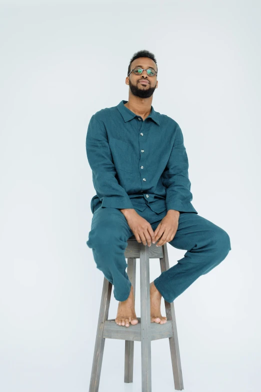 a man sits on a chair in a pair of pants