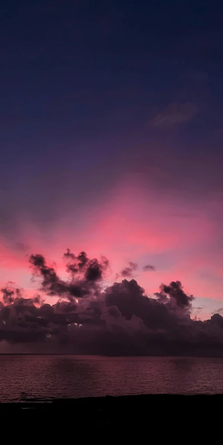 a sunset view with the clouds turning pink in the sun