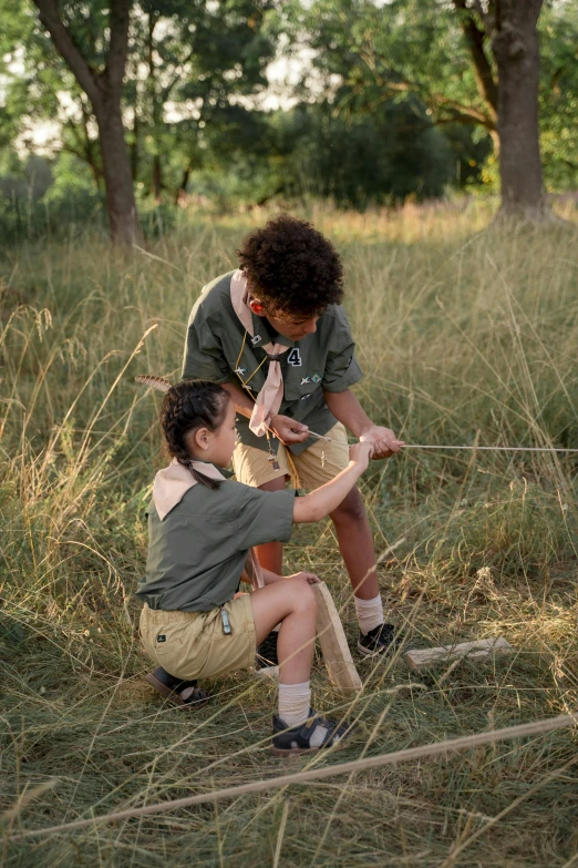 a couple of people that are in the grass, boy scout troop, aiming a bow and arrow, manuka, instagram picture