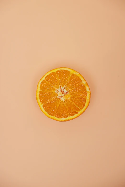 an orange cut in half on a pink surface, by Gavin Hamilton, trending on pexels, made of food, light tan, circle, ilustration