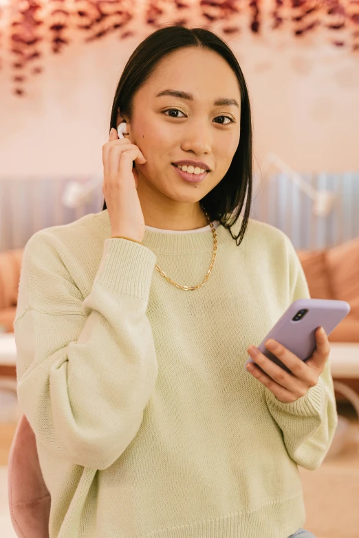 a woman holding a cell phone to her ear, inspired by helen huang, trending on pexels, soft and muted colors, dressed casually, south east asian with round face, curated collections