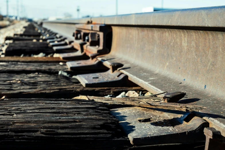 a close up of a rail road track, by Chris Rallis, unsplash, rusted panels, profile picture 1024px, demolition, wooden platforms