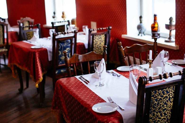 the restaurant's red walls reflect light on the table