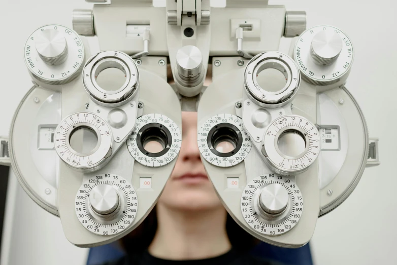 a close up of a person wearing a pair of glasses, a picture, medical image, dials, eye stalks, up-close