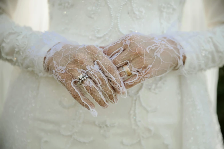 a close up of a person wearing a wedding dress, inspired by Hedda Sterne, gnarled fingers, white lace clothing, wearing jewellery, vintage style