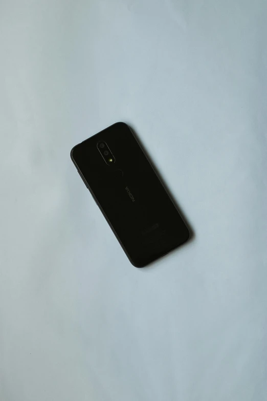 a close up of a cell phone on a table, pexels contest winner, dada, black color on white background, full body-n 9, low quality photo, silicone cover