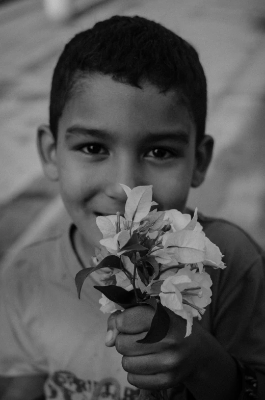 black and white po of a  holding a bunch of flowers