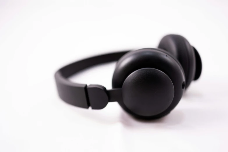 a pair of black headphones on a white surface, pexels, all black matte product, hairband, thumbnail, 2029