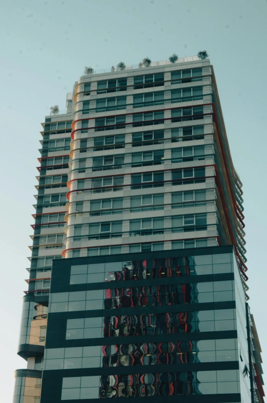 a tall building sitting in the middle of a city, freddy mamani silvestre facade, a medium shot, low quality photo, multiple stories