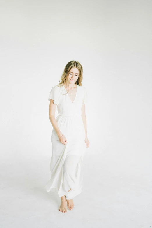 a woman standing in a white dress, by Sara Saftleven, minimalism, white backdrop, in wedding dresses, in style of britt marling, jen zee