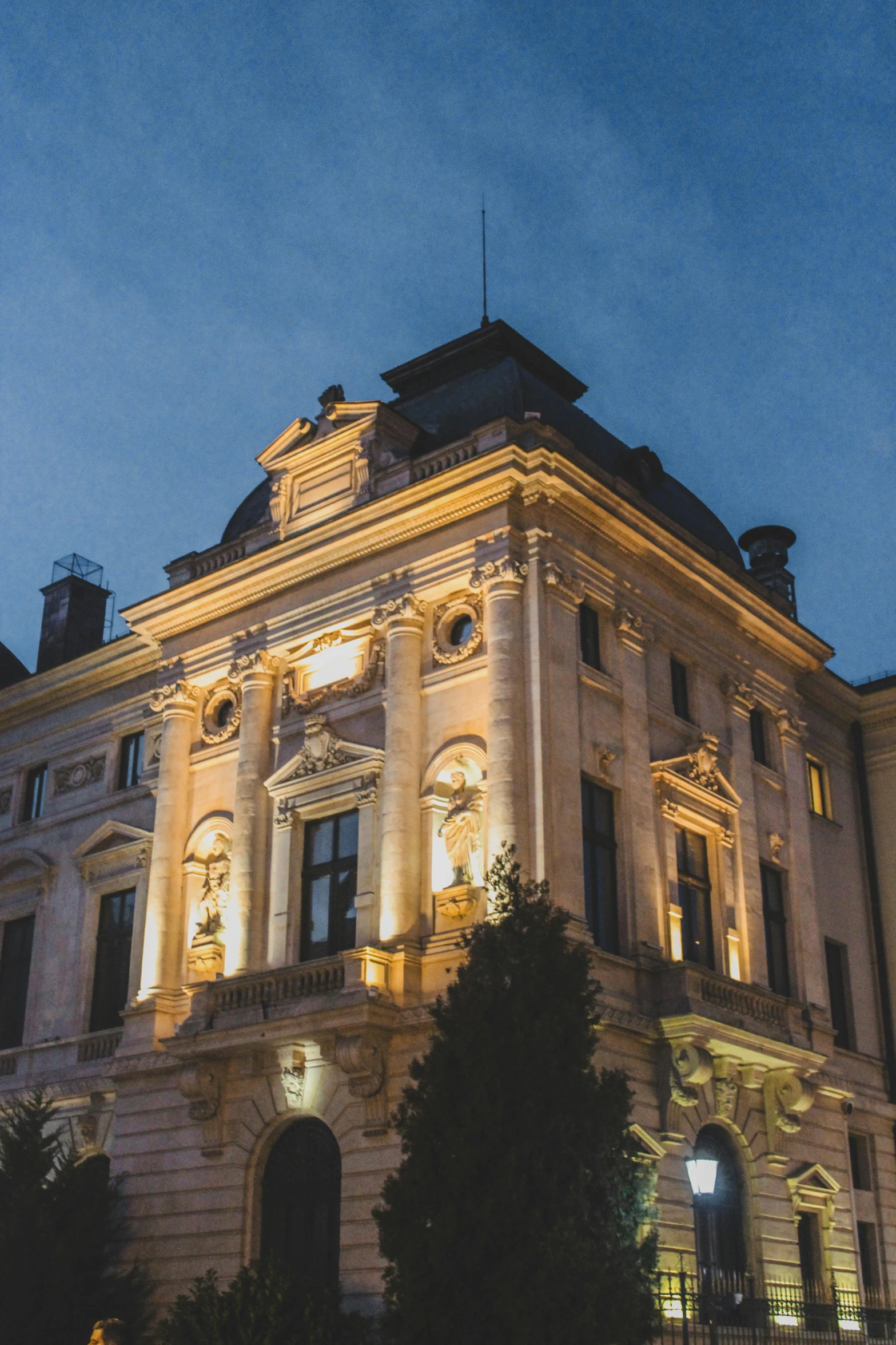 a large white building lit up at night, by Bertalan Székely, renaissance, pink marble building, profile image, delightful surroundings, switzerland