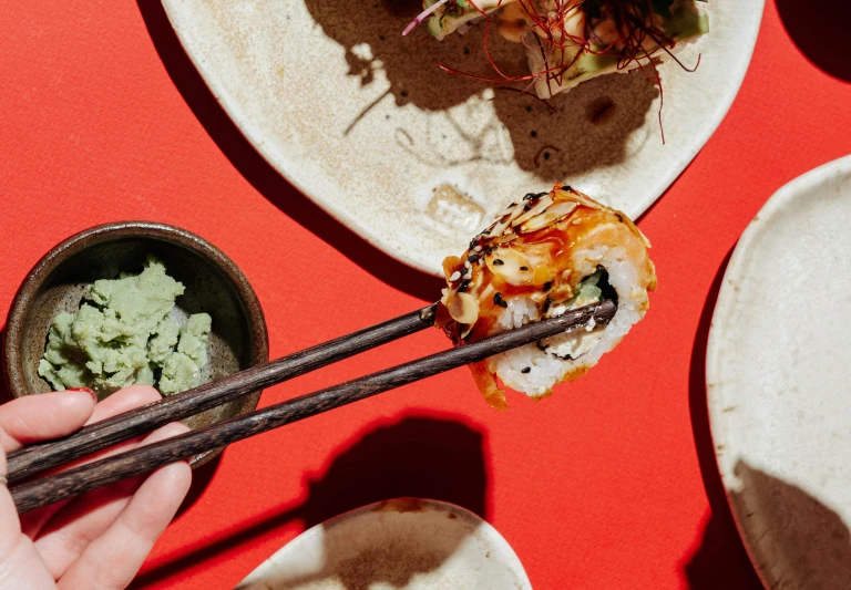 a person holding chopsticks over a plate of food, ukiyo, epicurious, a green, the best ever