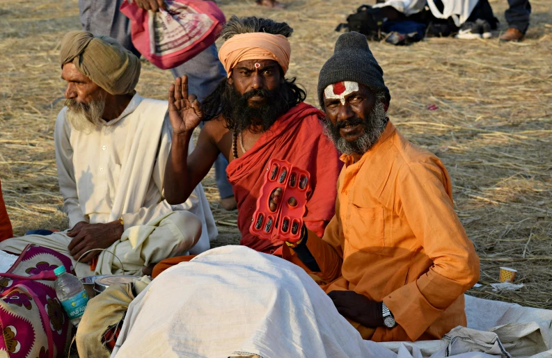 a group of men sitting next to each other, by Kailash Chandra Meher, pexels contest winner, pagans, with two characters, thumbnail, a pilgrim