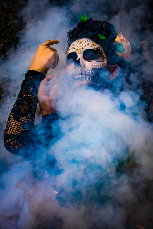 a person wearing a mask surrounded by smoke