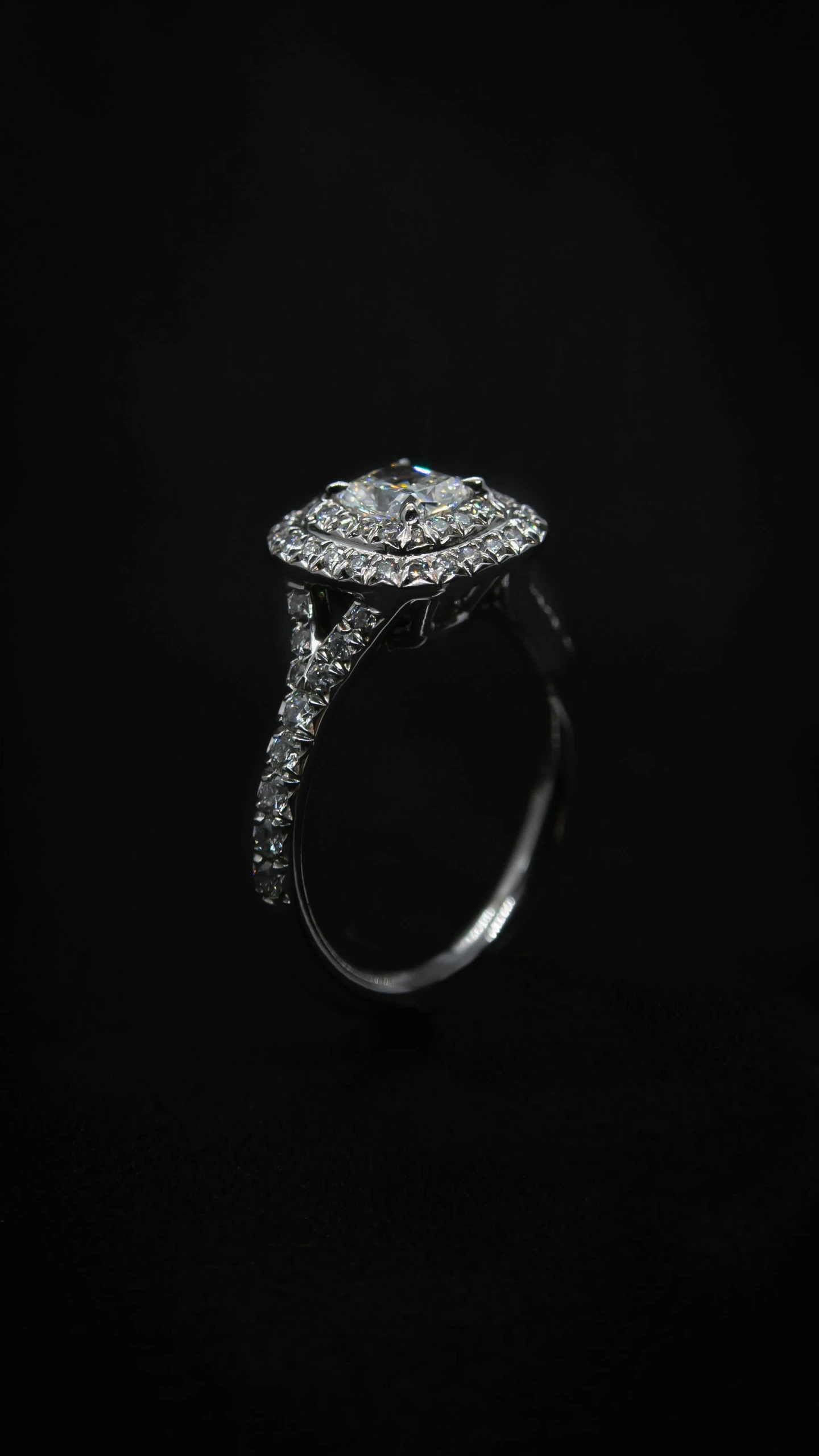 a close up of a ring on a black background, high-quality dslr photo”, square, view from the side, “diamonds