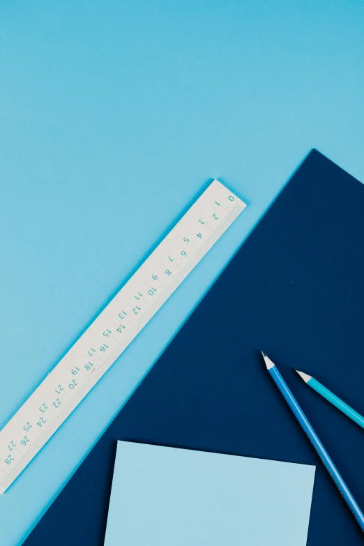 a notebook, pencils and ruler on a blue background, trending on unsplash, square shapes, ilustration, no - text no - logo, blue: 0.5