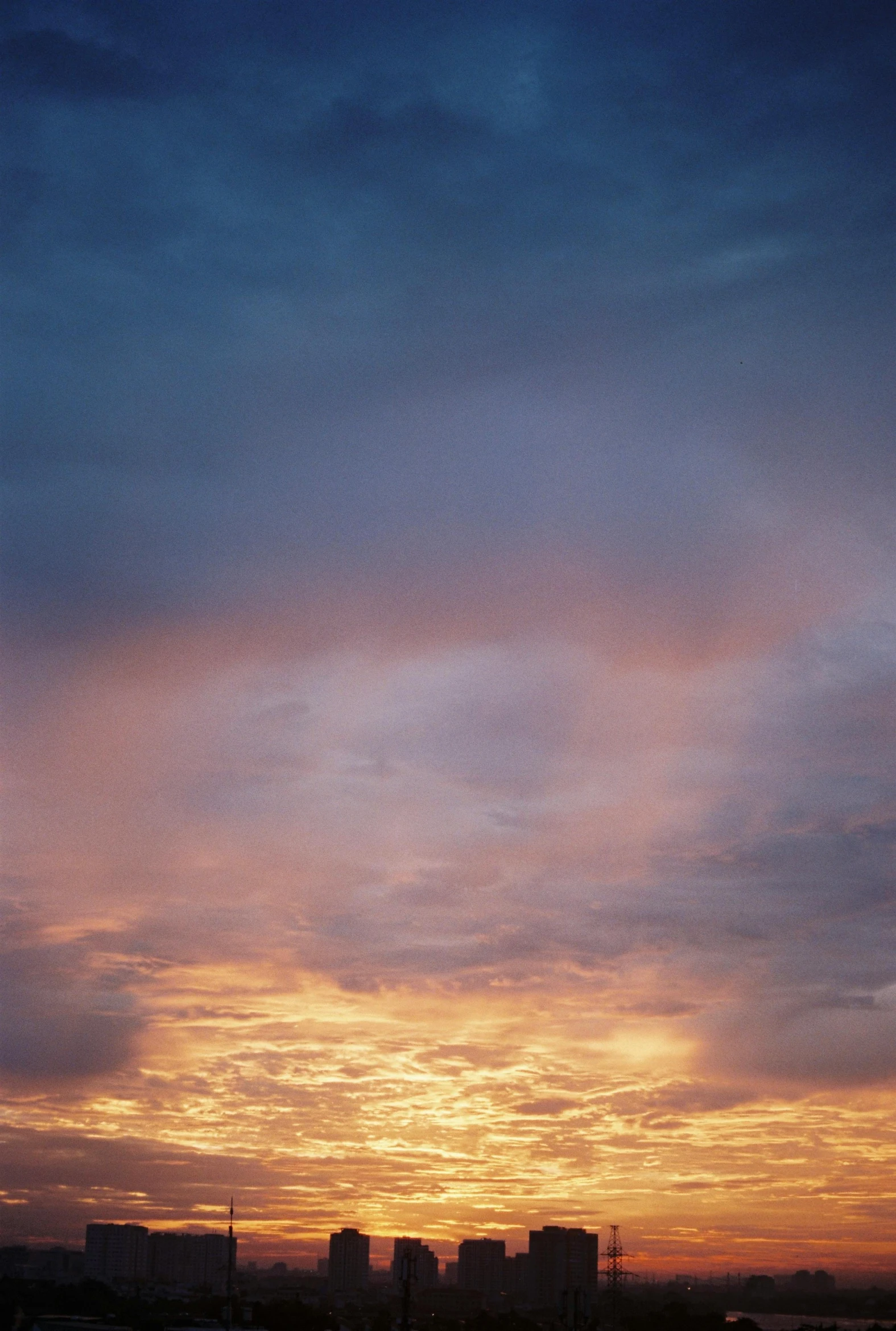 the sky in an orange, yellow and blue sky is very large