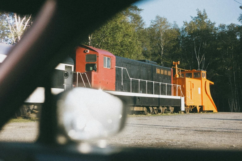 a train traveling down train tracks next to a forest, a picture, vhs colour photography, big engine, maintenance photo, in the yard