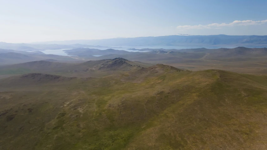 the landscape is full of brown grass and blue water