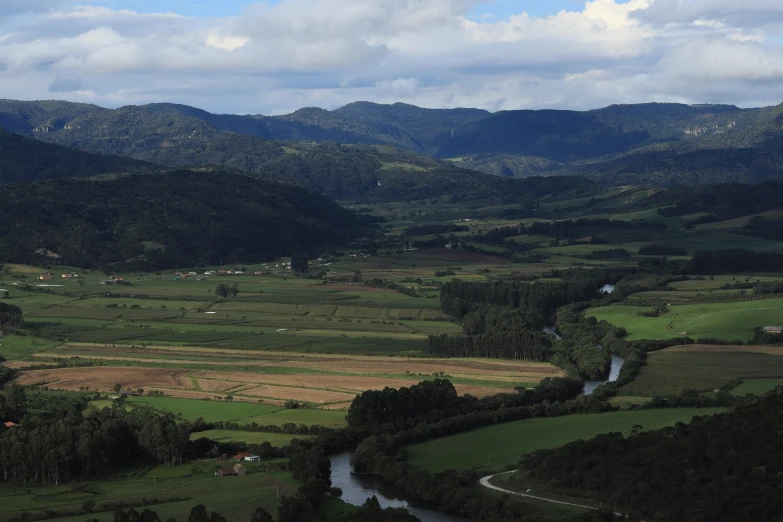 an aerial view shows lush green landscape and rolling hills