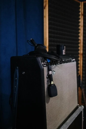 a close up of a guitar amplifier in a room, sitting in front of a microphone, audeze, 1 / 4 headshot, cords
