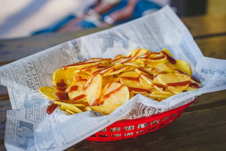 a basket of chips and ketchup on a table, by Joe Bowler, unsplash, brown sauce, square, “ iron bark, on a sunny day