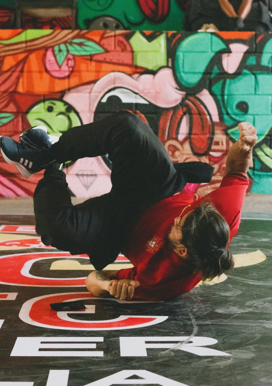 a man who is doing a flip on a skateboard