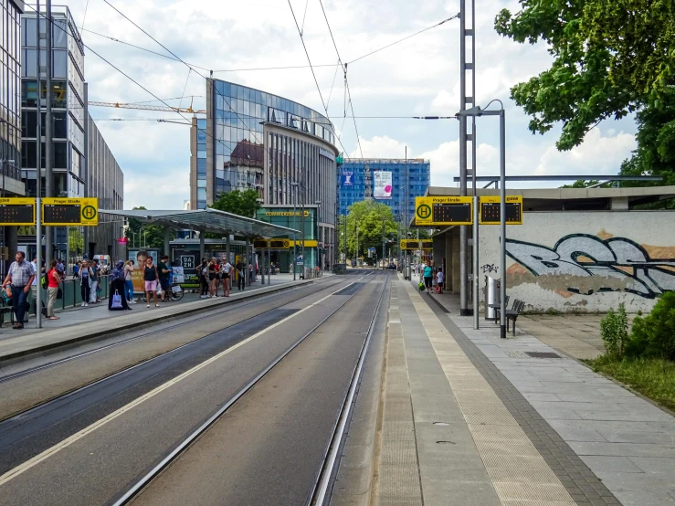 a city street is lined with tracks and people