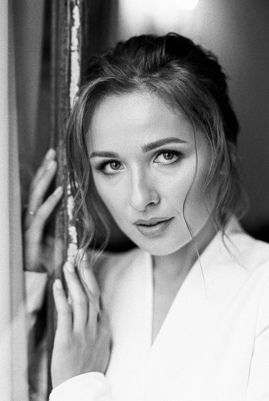 a black and white photo of a woman leaning against a wall, inspired by Yousuf Karsh, pexels contest winner, arabesque, zoe kazan, sophie turner, portrait of a cute woman, gif