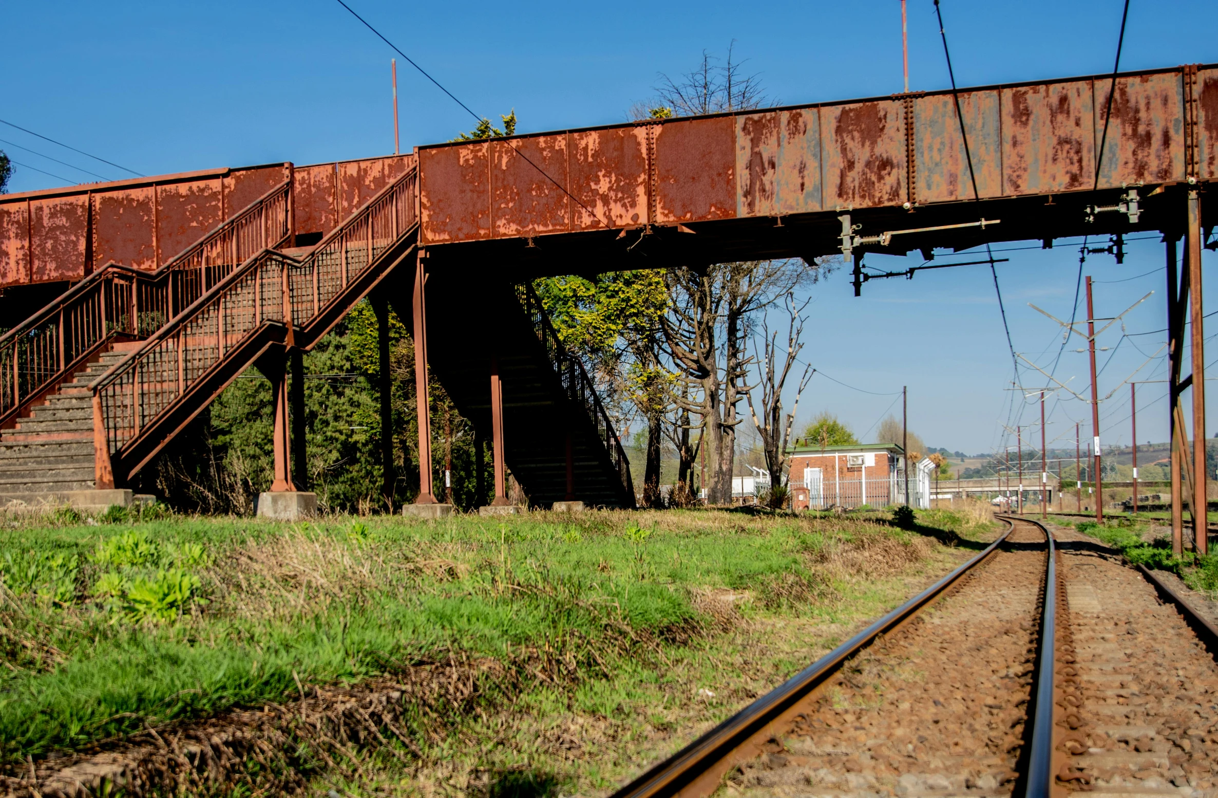 a close up of a train track near a bridge, renaissance, southern slav features, exterior photo, ((rust)), panorama