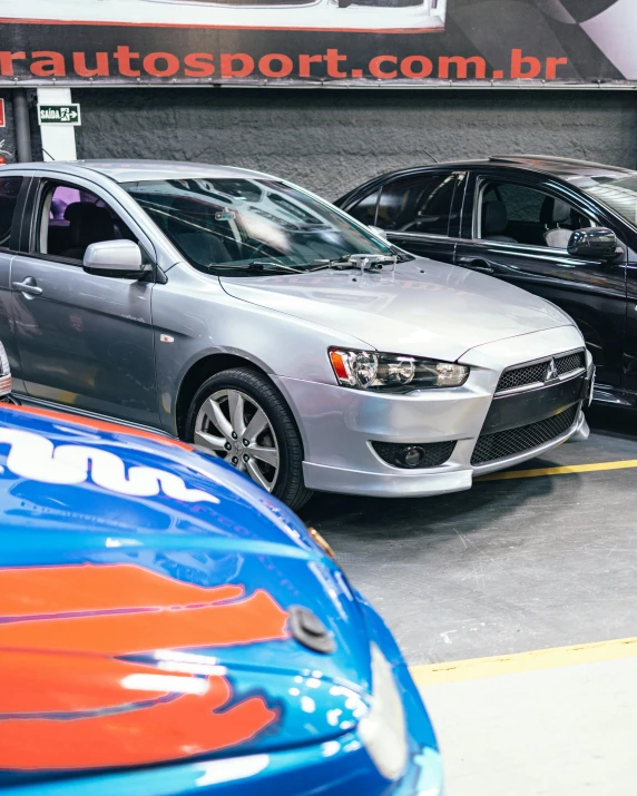 several cars parked in a row with other ones nearby