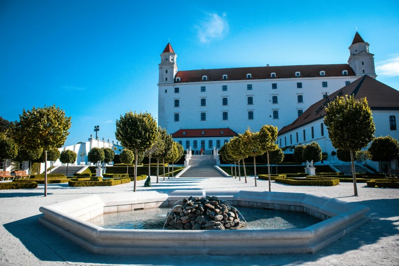 the white building has a long courtyard with lots of stairs