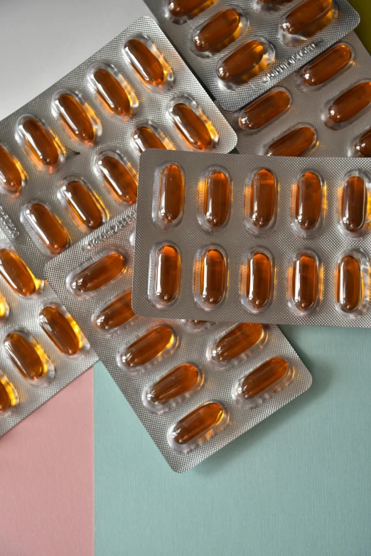 two rows of pills on a color background