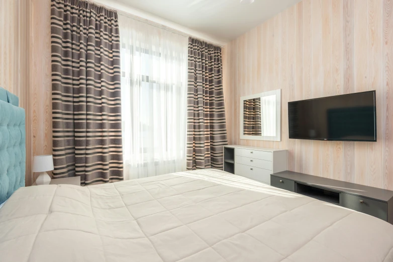 a bedroom with a flat screen tv mounted on the wall