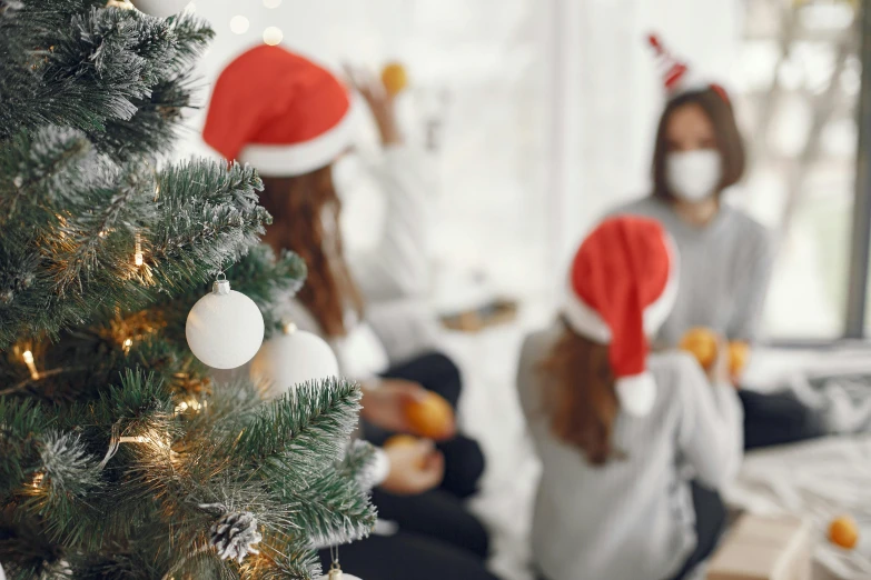 two girls in santas hats eating christmas food