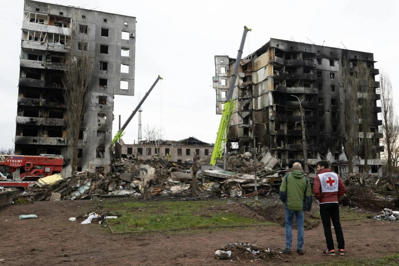 a couple of people standing in front of a building, auto-destructive art, collapsed buildings, russia in 2 0 2 1, ap, grey