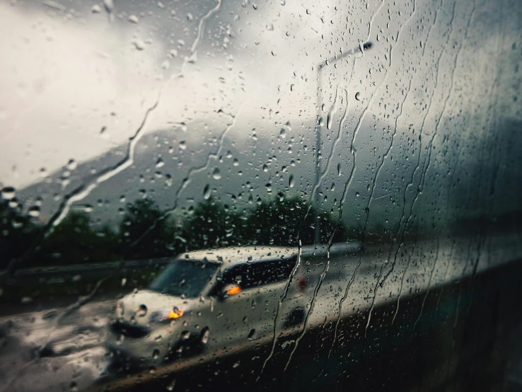 a car driving down the road in the rain, paul barson, fan favorite, raining outside the window, dash cam