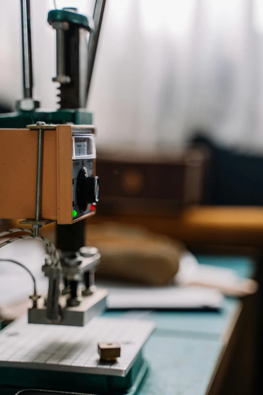 a close up of a machine on a table, unsplash, private press, brown, smart textiles, laboratory, colorized