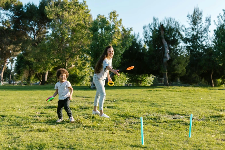 a couple of kids playing a game of frisbee, pexels contest winner, figuration libre, parks and gardens, avatar image, albuquerque, thumbnail