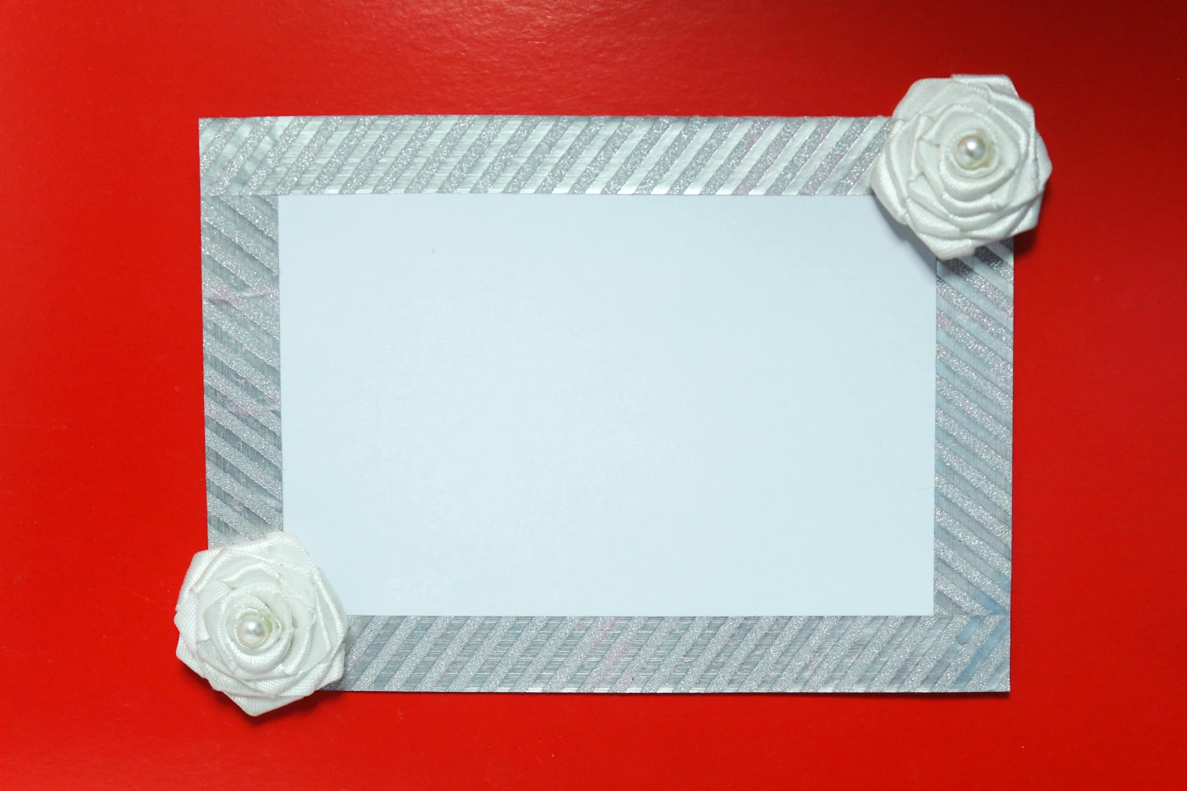 a picture frame with white roses on a red background, inspired by Masamitsu Ōta, pexels contest winner, mail art, grey and silver, glitter sticker, 'white background'!!!, paper origami