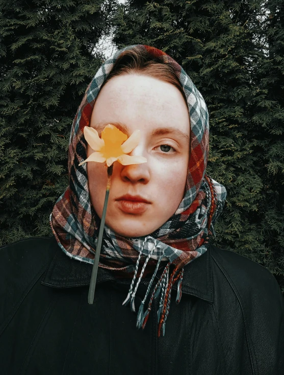 a woman wearing a scarf holding a flower in front of her face, inspired by Anna Füssli, unsplash contest winner, hyperrealism, portrait of a patchwork boy, 🍁 cute, snapchat photo, trending on vsco
