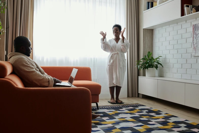 a man standing in front of a living room filled with furniture