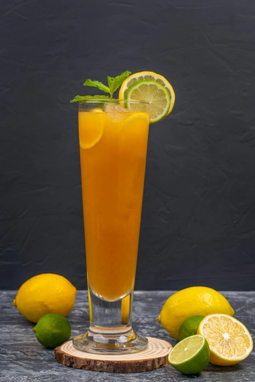 a tall glass filled with orange juice next to lemons, mint, on a gray background, scorpion tail, thumbnail