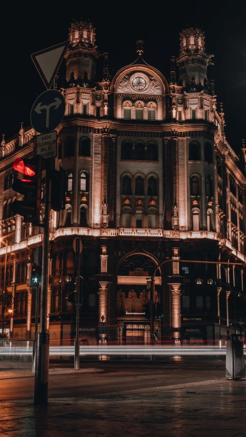 an old building in a city with lights in the night