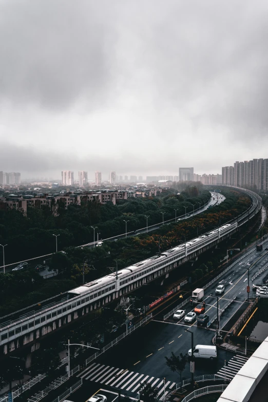 a train on a track traveling along a highway